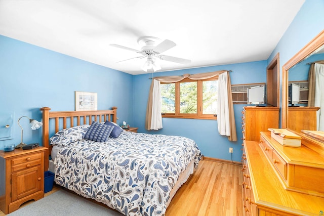 bedroom with light wood-style flooring, baseboards, and ceiling fan