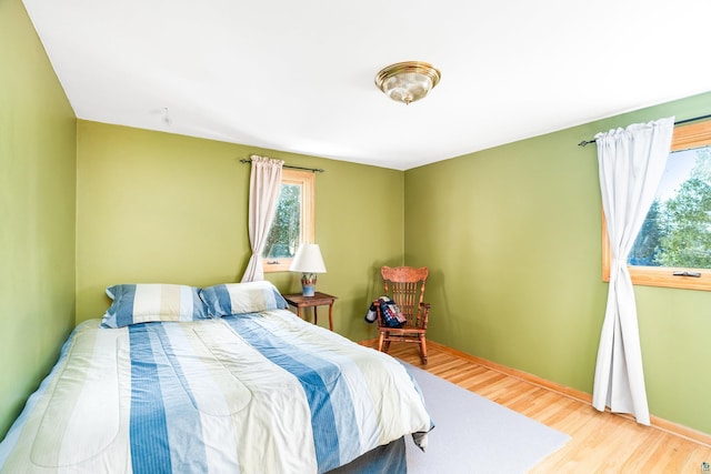 bedroom with baseboards and wood finished floors