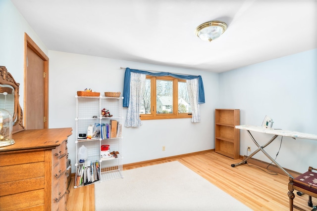 interior space with baseboards and wood finished floors