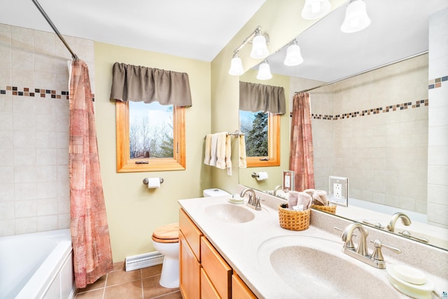 bathroom featuring tile patterned floors, toilet, a baseboard radiator, and a sink