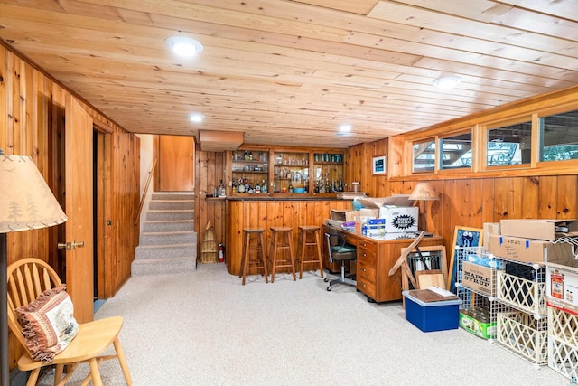 home office featuring wooden walls, wood ceiling, carpet floors, recessed lighting, and a bar