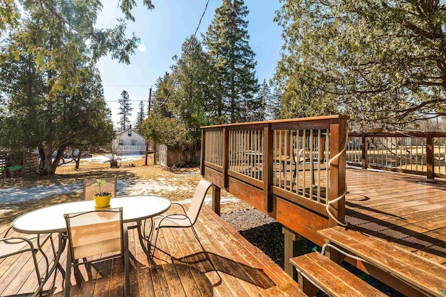 wooden deck featuring outdoor dining area