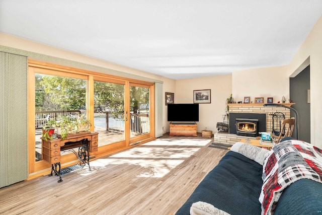 living area with a fireplace and wood finished floors