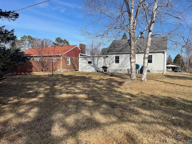 rear view of property with a lawn