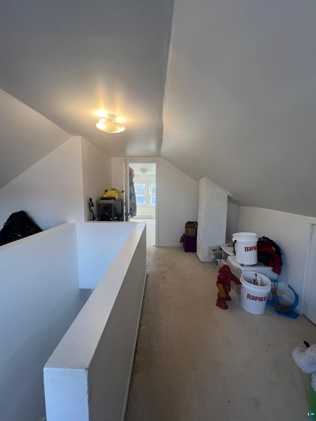 interior space featuring light carpet and vaulted ceiling