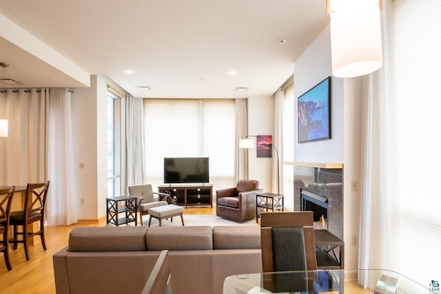 living room with a fireplace and light wood-style floors