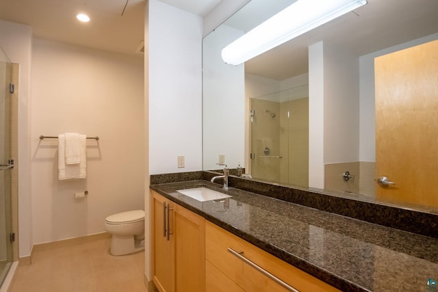 bathroom with vanity, baseboards, recessed lighting, a shower stall, and toilet