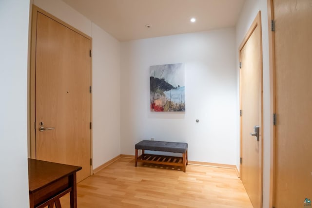 living area with light wood finished floors and recessed lighting