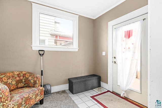 foyer featuring light tile patterned floors, baseboards, and ornamental molding