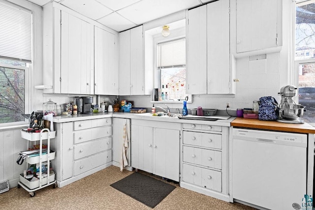 kitchen featuring dishwasher, white cabinetry, and light countertops