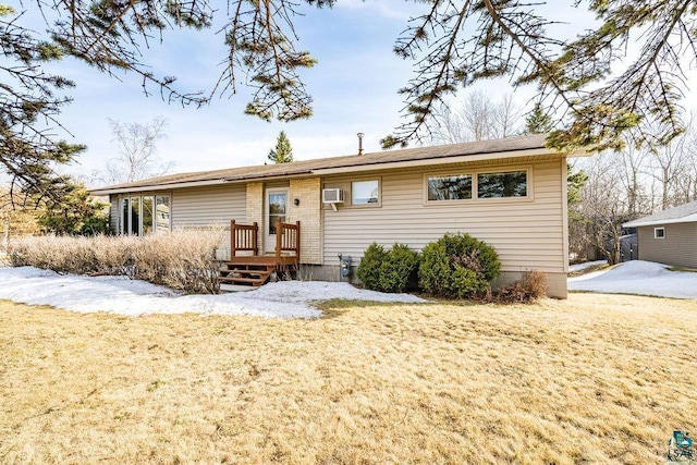 ranch-style house featuring a wall mounted AC