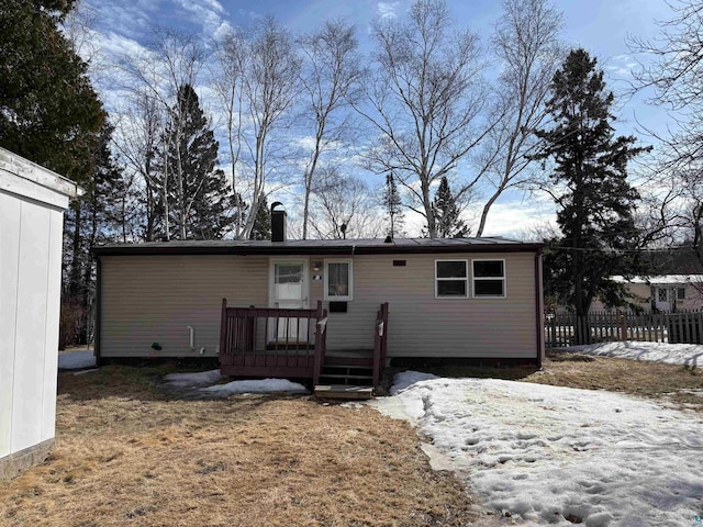 back of house with a deck and fence