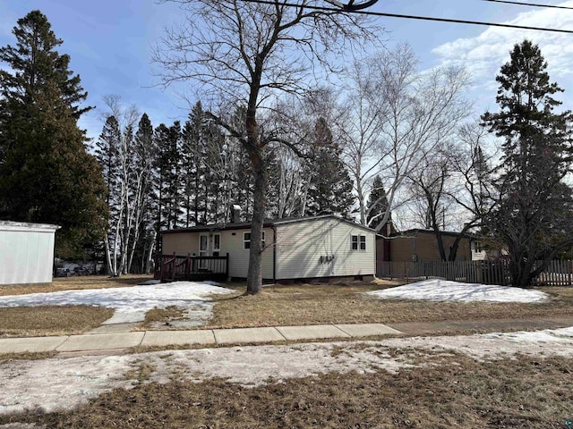 view of side of home featuring fence