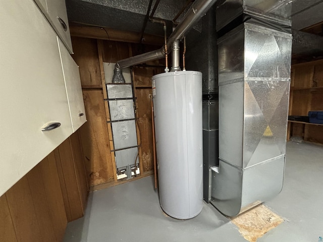 utility room featuring gas water heater and heating unit