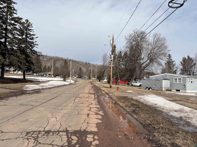 view of road with curbs, sidewalks, and street lighting