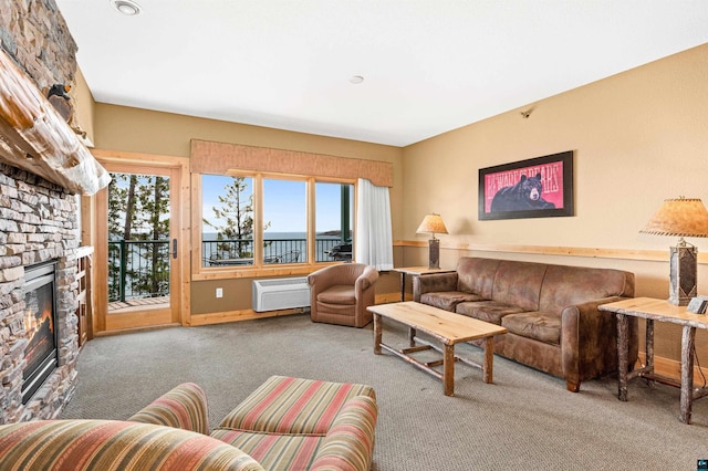 living room featuring carpet floors, a stone fireplace, and a wall unit AC