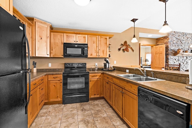 kitchen with a sink, decorative light fixtures, and black appliances