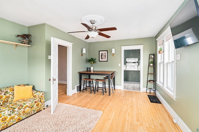 foyer with visible vents, baseboards, a ceiling fan, and hardwood / wood-style floors