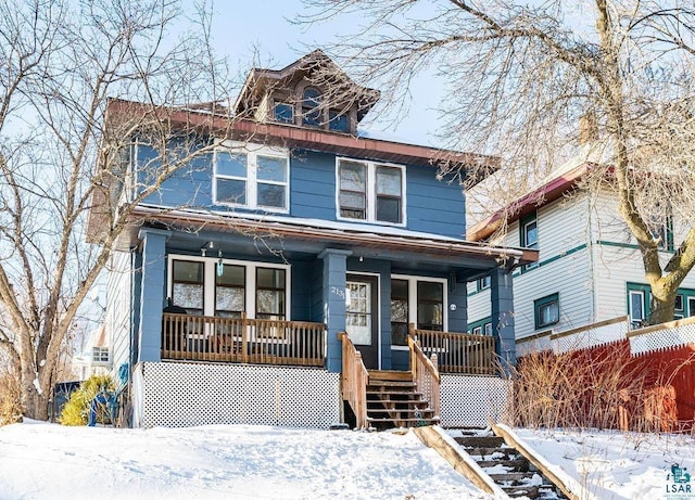 american foursquare style home featuring covered porch