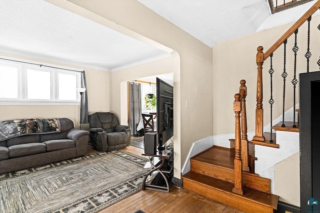 living room featuring plenty of natural light, stairs, and hardwood / wood-style flooring