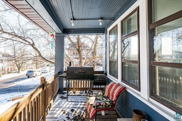 snow covered deck featuring area for grilling