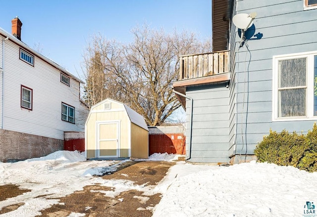 exterior space with an outbuilding, fence, and a shed