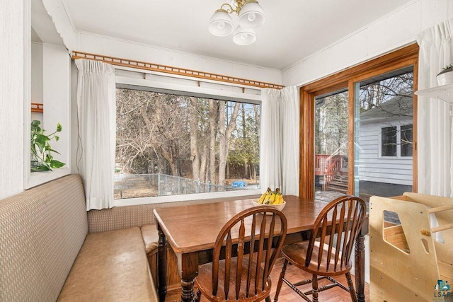 dining area with an inviting chandelier and crown molding