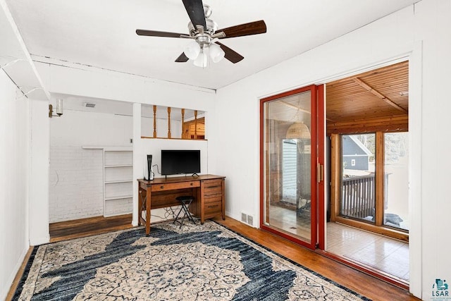 office space with visible vents, wood finished floors, and a ceiling fan