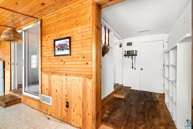 hall with wooden walls and visible vents