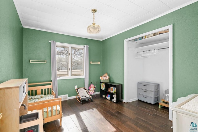 bedroom with visible vents, baseboards, ornamental molding, and dark wood-style flooring