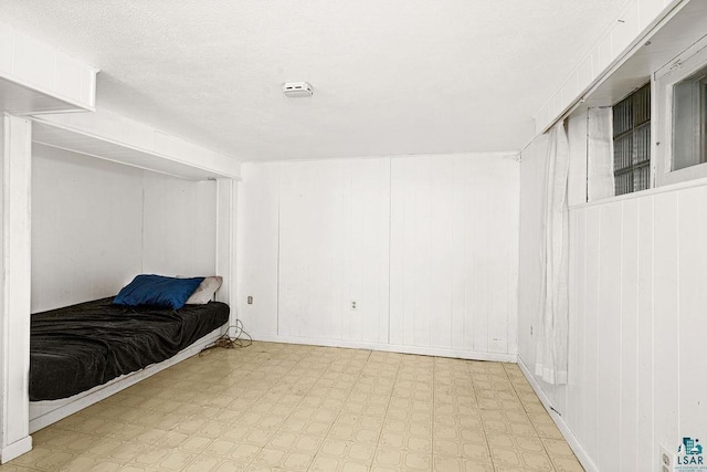 bedroom featuring light floors and a textured ceiling