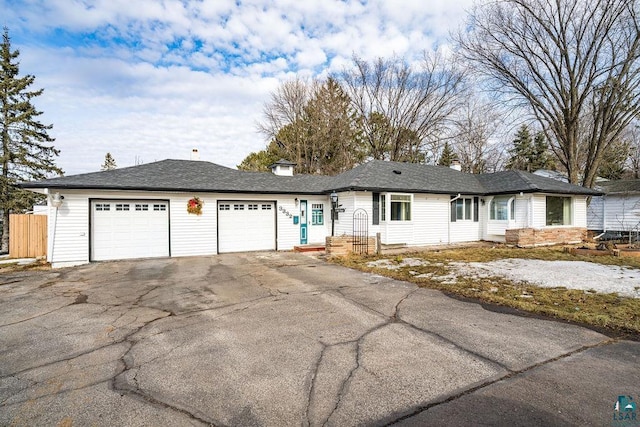 single story home with fence, a garage, and driveway