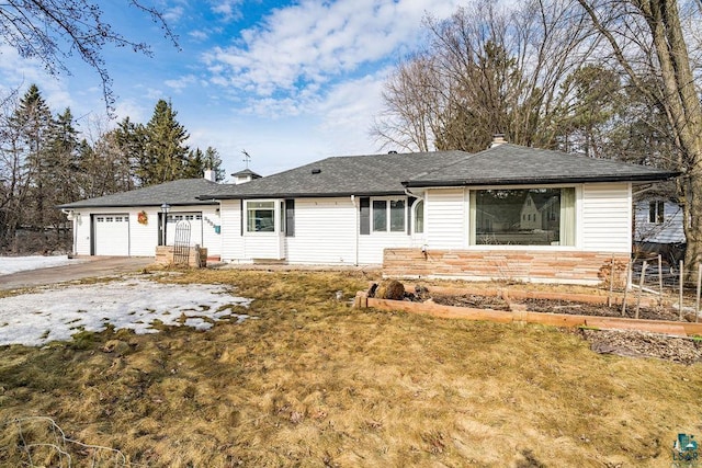 single story home featuring a garage and a chimney