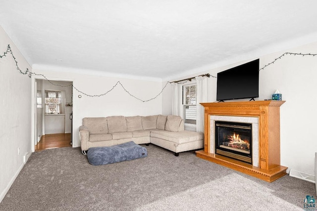 living area featuring carpet and a high end fireplace