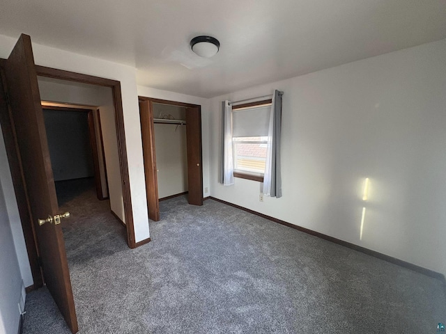 unfurnished bedroom featuring a closet, baseboards, and carpet floors