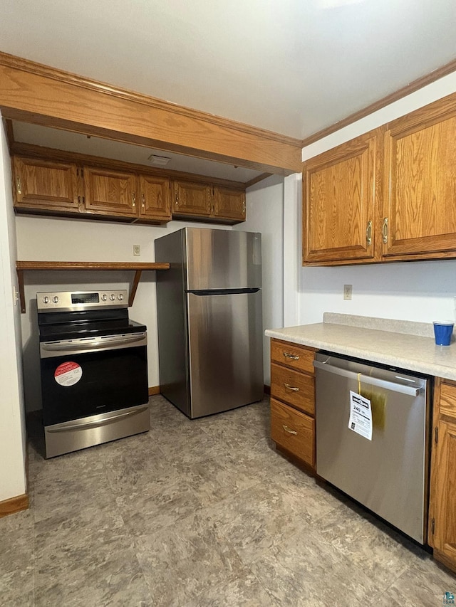 kitchen with light countertops, brown cabinetry, and stainless steel appliances