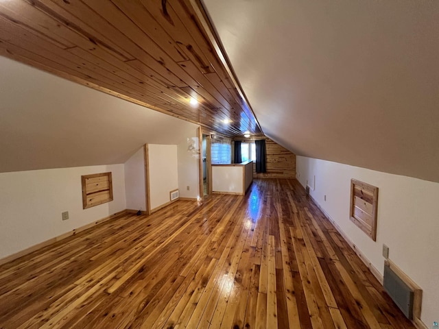 additional living space featuring hardwood / wood-style floors, wooden ceiling, visible vents, and vaulted ceiling