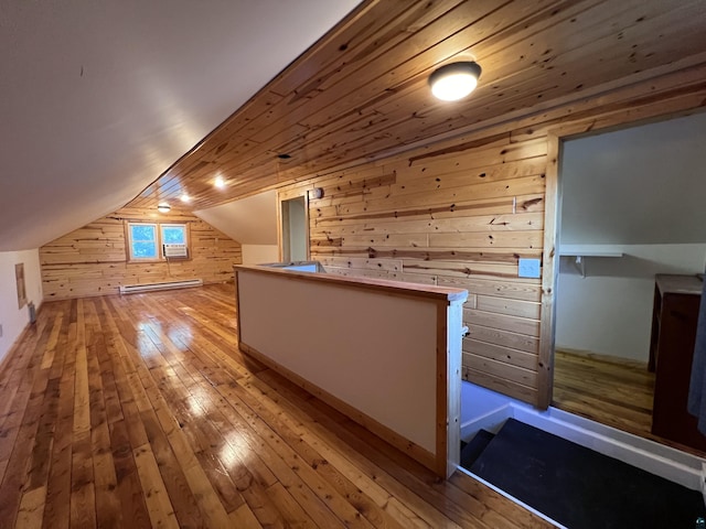 bonus room featuring wooden walls, light wood finished floors, a baseboard radiator, lofted ceiling, and wood ceiling