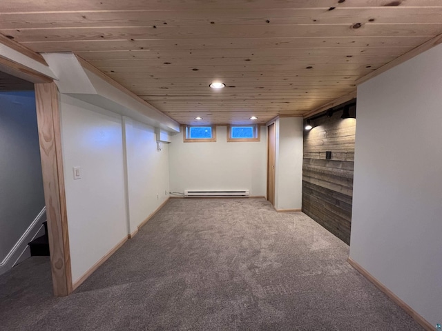 below grade area featuring carpet flooring, recessed lighting, baseboards, and a baseboard radiator