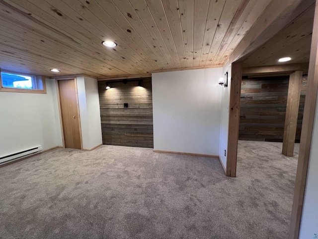 below grade area featuring wooden ceiling, wooden walls, baseboards, and carpet floors