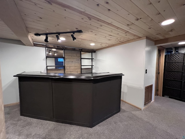 kitchen with carpet flooring, rail lighting, wood ceiling, and baseboards