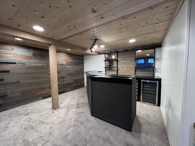 bar with indoor wet bar, light carpet, wooden walls, and wood ceiling