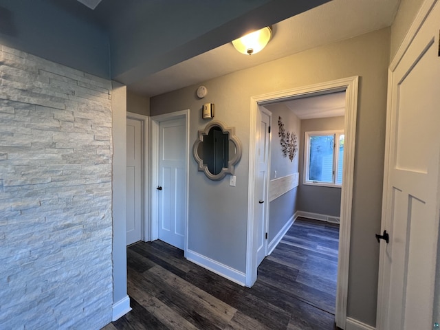 hall with baseboards and dark wood-style flooring