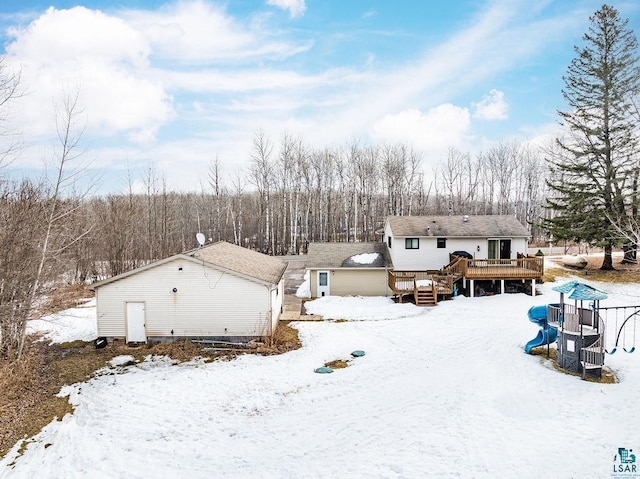 snow covered house featuring a deck