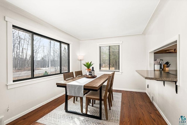 dining area featuring visible vents, baseboards, and dark wood-style floors