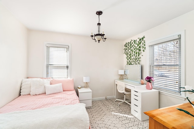 bedroom with baseboards, multiple windows, light colored carpet, and a notable chandelier