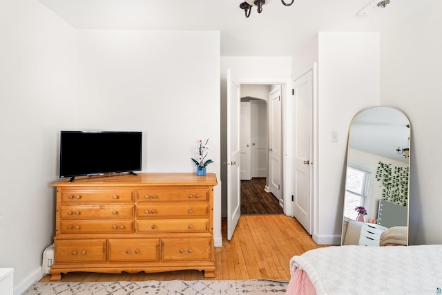 bedroom with baseboards and light wood-type flooring