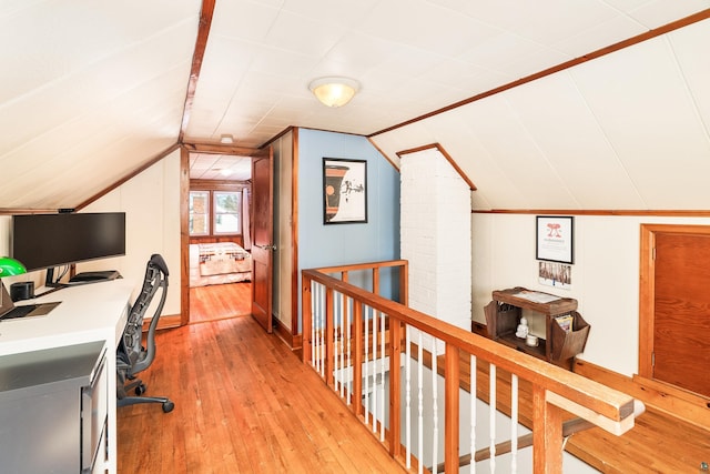 home office with light wood finished floors and lofted ceiling