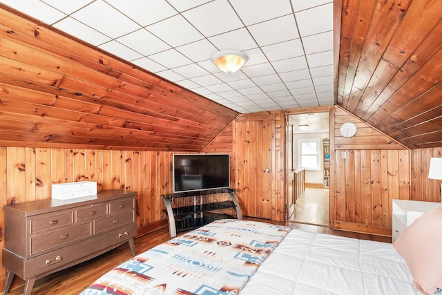 bedroom featuring wooden walls, wood ceiling, wood finished floors, and vaulted ceiling