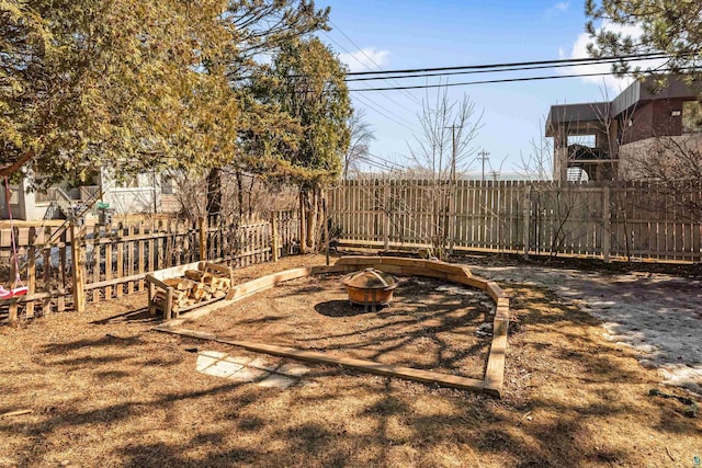 view of yard featuring an outdoor fire pit and a fenced backyard